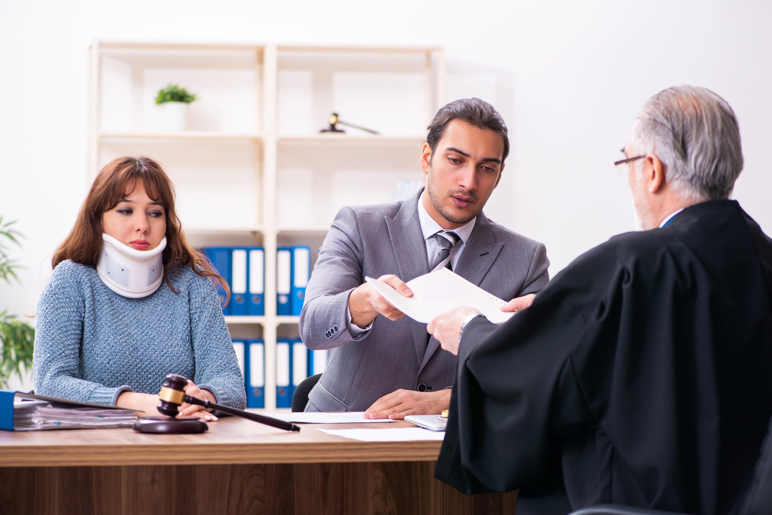 Young woman in courthouse with judge and lawyer Young woman in courthouse with judge and lawyer
