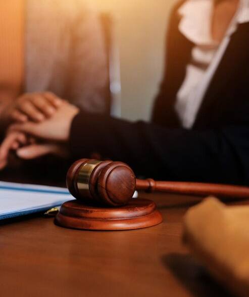 judge-gavel-with-justice-lawyers-having-team-meeting-law-firm-background (1)
