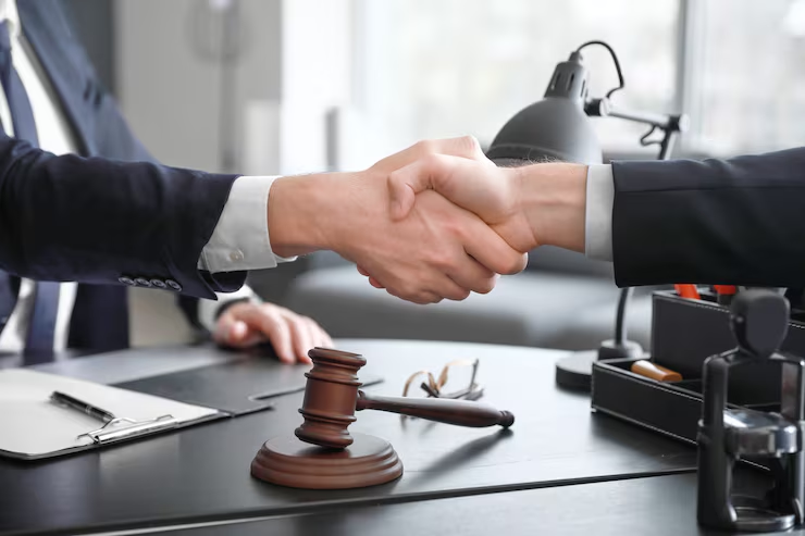 male-lawyer-with-client-shaking-hands-office