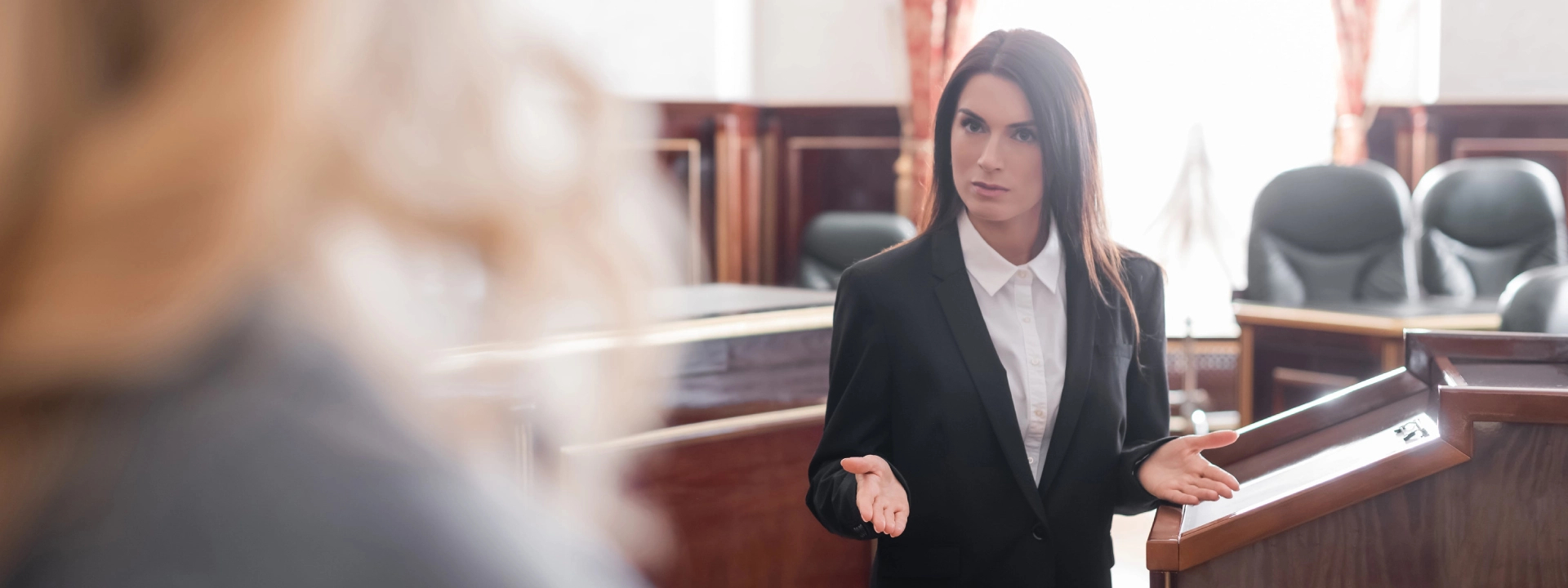 prosecutor talking to blurred witness during questioning in trial (1)