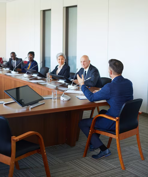 rear-view-businessman-talking-his-colleagues-while-they-sitting-table-board-room1